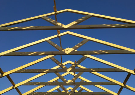 building a new roof. wooden frame for building a new roof or repairing an old one. wooden structures. environmentally friendly material for building a house.の写真素材