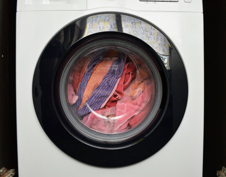 closed drum of the washing machine. washing things. household washing machines for cleaning and washing clothes and clothesの写真素材