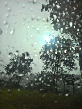 Focus on the background, drizzling on the side glass of the car in the afternoon.の写真素材