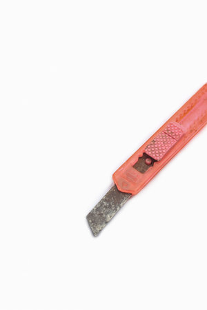 Rusty cutter pink or paper knife isolated on white background.の写真素材