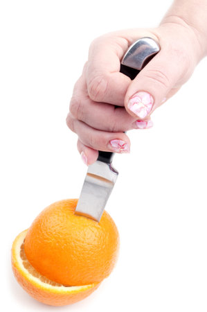 knife and orange on a white background