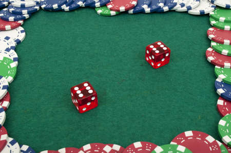 dice and chips on a green tableの写真素材