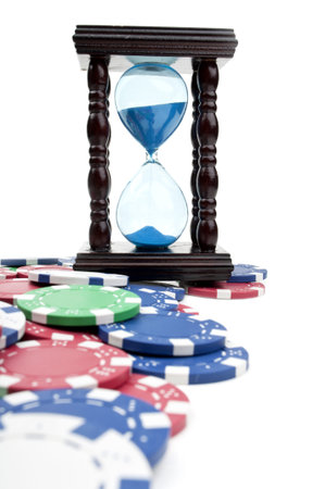 hourglass and poker chips isolated on a white background