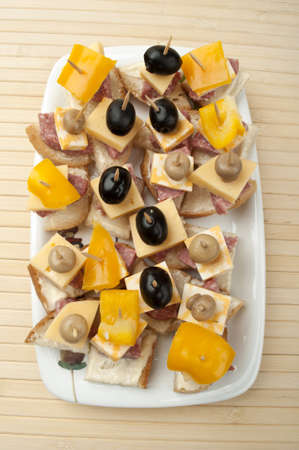 bit with cheese and olives on a wooden backgroundの写真素材
