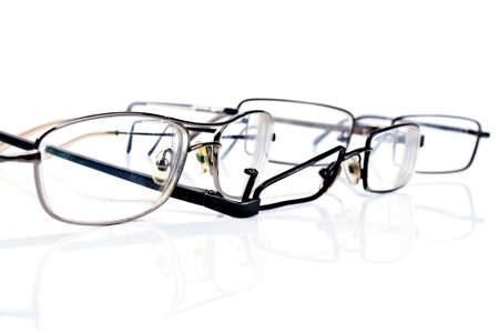 broken black eyeglasses isolated on a white backgroundの写真素材