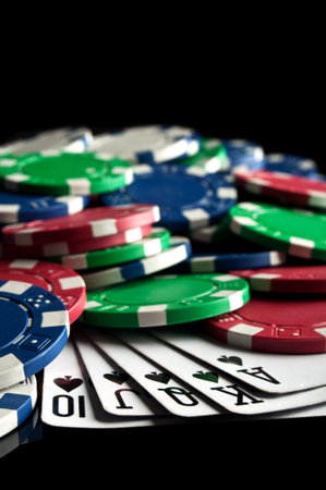 royal flush and poker chips on a black background