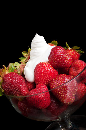 appetizing strawberry and cream on a black backgroundの写真素材