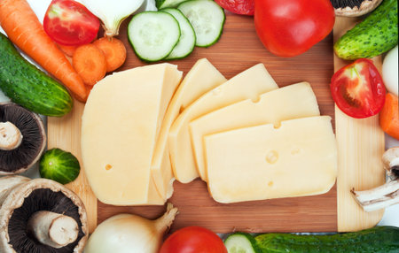 fresh vegetables and cheese on the board 
