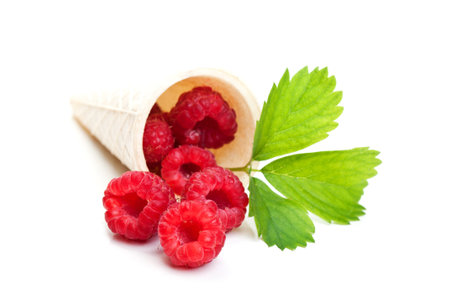fresh raspberry and green leaf isolated on a white background