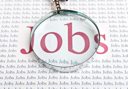 job search with a magnifying glass backgroundの写真素材