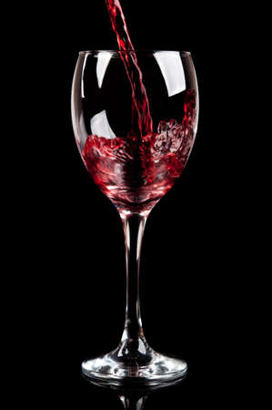 glass of red wine isolated on a black backgroundの写真素材