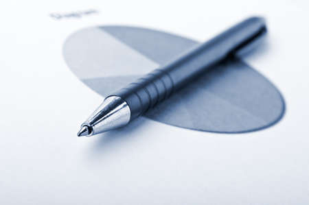 pen and finance diagram on a table in officeの写真素材