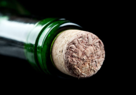 macro photo of wine bottle isolated on a black background