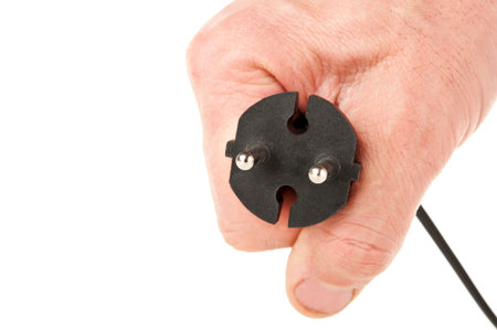 man holding an electric plug isolated on a white background