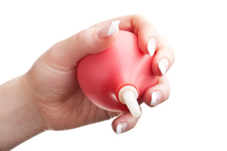 woman holding an enema isolated on a white backgroundの写真素材