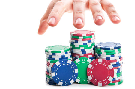 man's hand reaches out to the poker chips