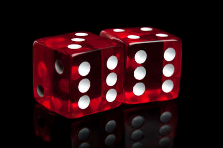 closeup of dice isolated on a black backgroundの写真素材