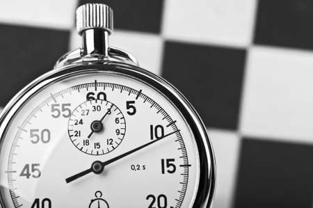 stopwatch and chessboard on a backgroundの写真素材