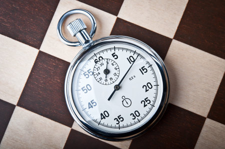 stopwatch and chessboard on a backgroundの写真素材