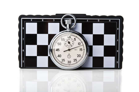 stopwatch and chessboard on a backgroundの写真素材