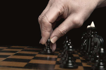 man plays chess and makes the first move a pawnの写真素材