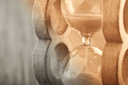retro hourglass on wodden backgroundの写真素材