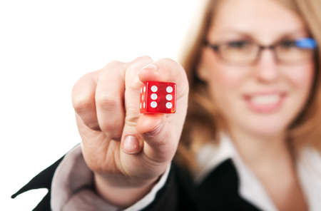 young beautiful girl holding dice isolated on a white backgroundの写真素材