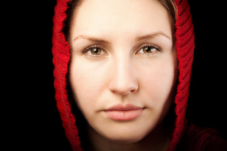 portrait of young beautiful woman with red hoodの写真素材