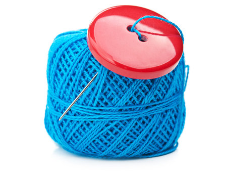 button and ball yarn isolated on white background