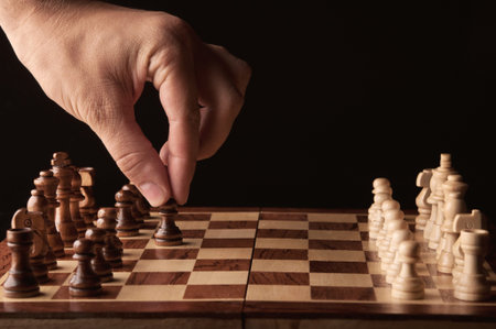 man plays chess and makes the first move a pawn
