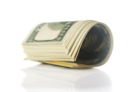 pack of 100 dollars isolated on a white background