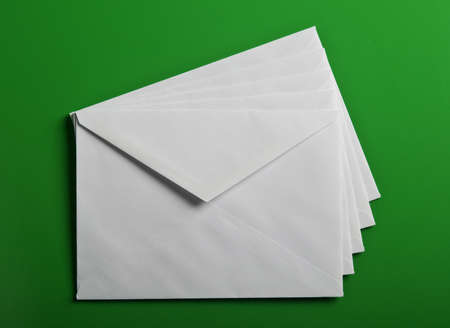 Papers envelope on green backgroundの写真素材
