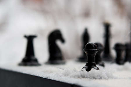 winter chess pieces pawn on snowの写真素材