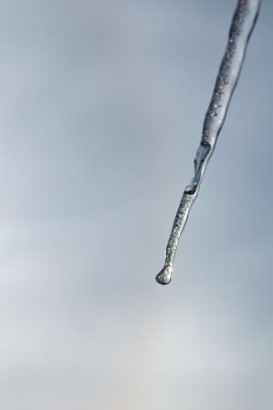 Icicle with glare of the sun backgroundの写真素材