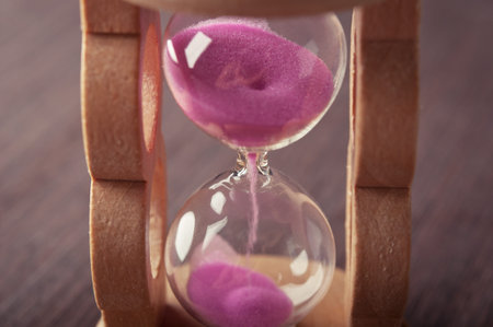 hourglass clock on wooden table