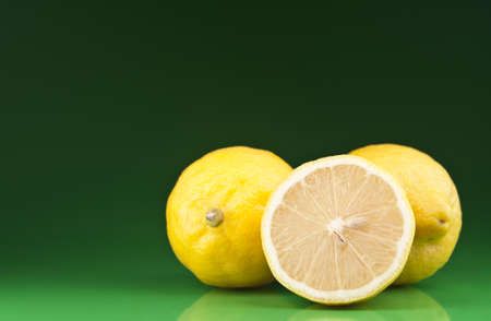 fresh lemons on green backgroundの写真素材