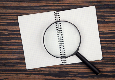 loupe and notebook on backgroundの写真素材