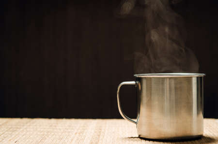 hot cup of coffee on black backgroundの写真素材