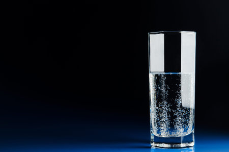 glass of water on dark background