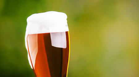 Fresh beer with foam on nature backgroundの写真素材