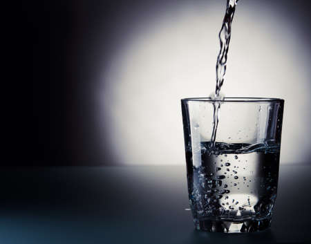 cold water pouring into a glassの写真素材