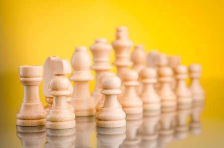 chess pieces standing on glass tableの写真素材
