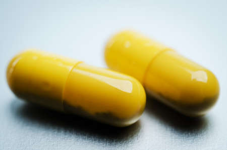 close up of two yellow capsuleの写真素材