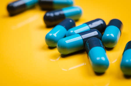 close up of pills on yellow backgroundの写真素材