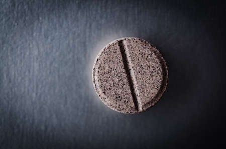 close up of one pill on dark backgroundの写真素材