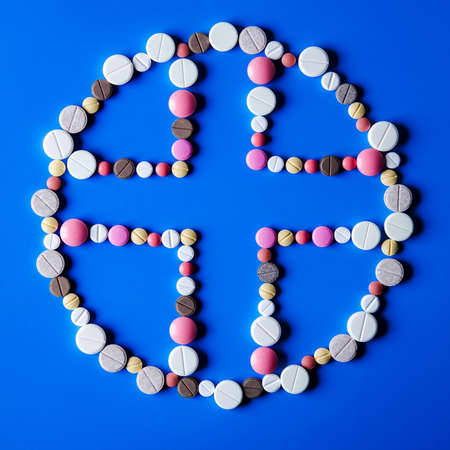 cross of tablets on blue backgroundの写真素材