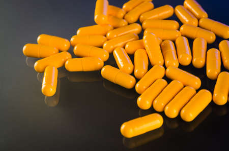 yellow medical capsule on backgroundの写真素材