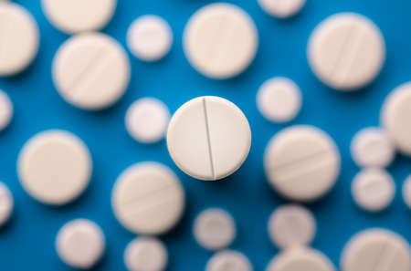 white pills on blue backgroundの写真素材