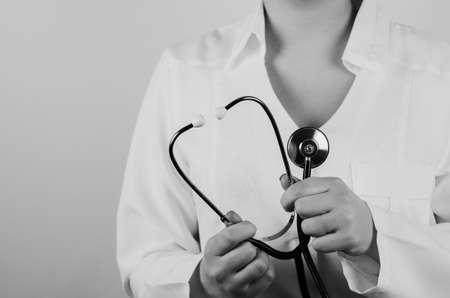 woman doctor holding stethoscope on backgroundの写真素材