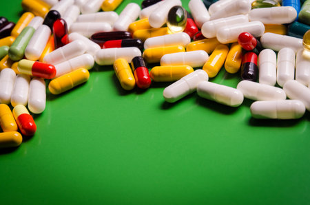 colored capsules on green background